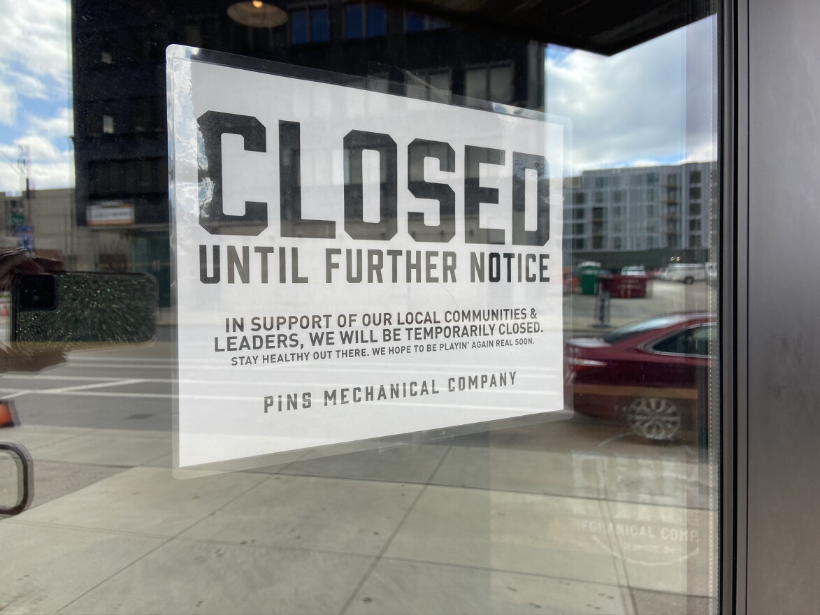 A "closed" sign is posted on a closed duckpin bowling alley and bar in downtown Columbus.
